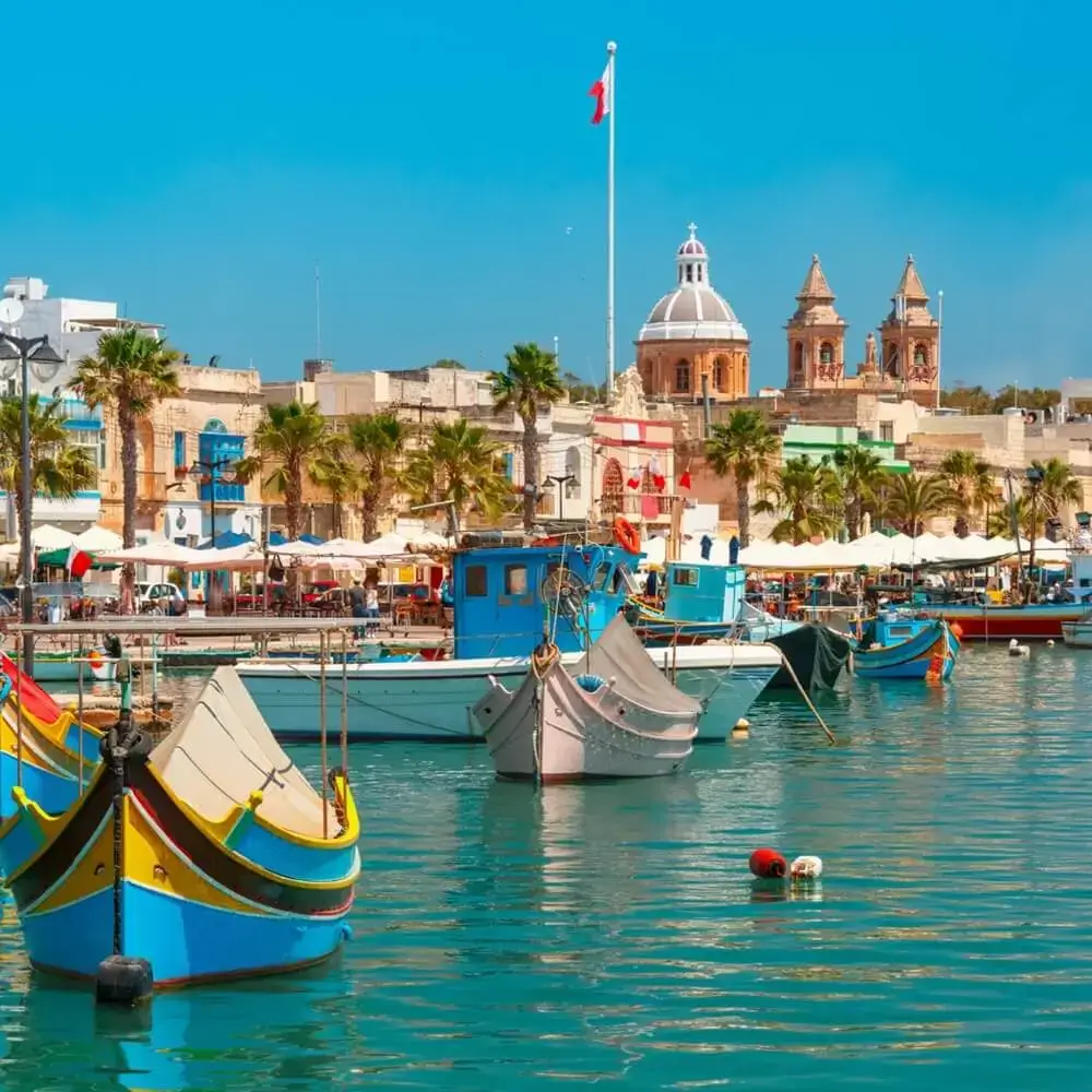Painted luzzu fishing boats in the harbour at Marsaxlokk, Malta